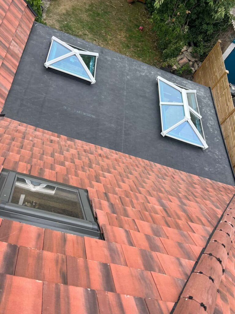 This is a photo taken from the roof ridge looking down a tiled pitched roof on to a flat roof. Works carried out by TRP Roofing Withernsea