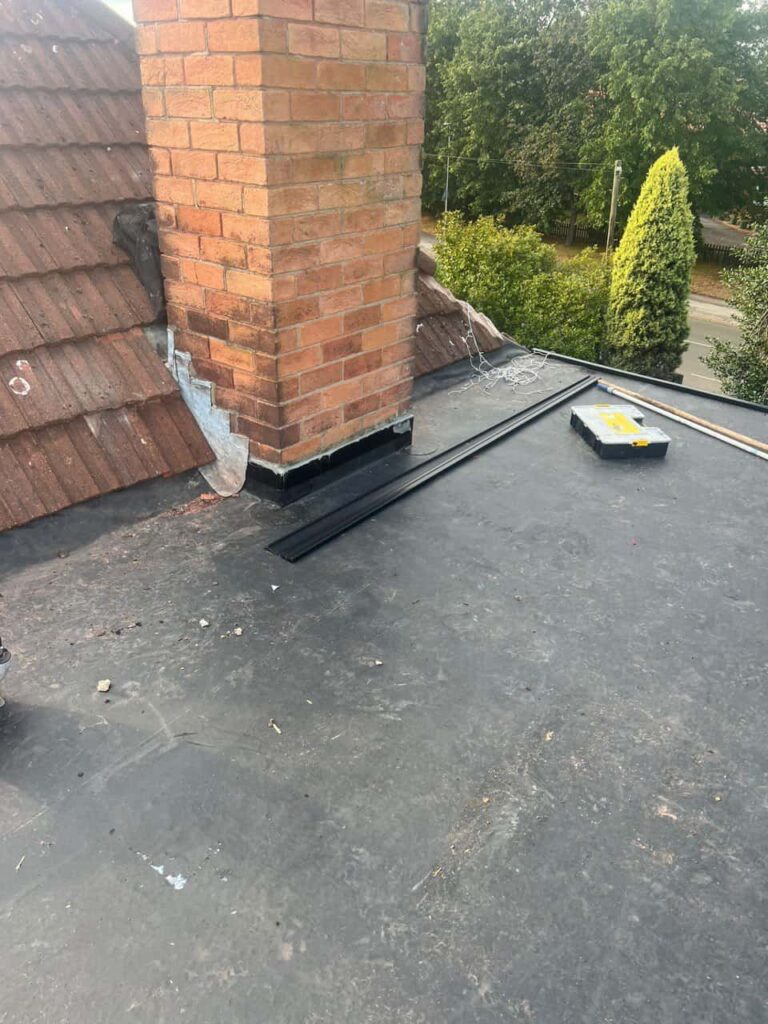This is a photo of a flat roof which has just been repaired, there is also a chimney stack and some leadwork has also been dressed. Works carried out by TRP Roofing Withernsea